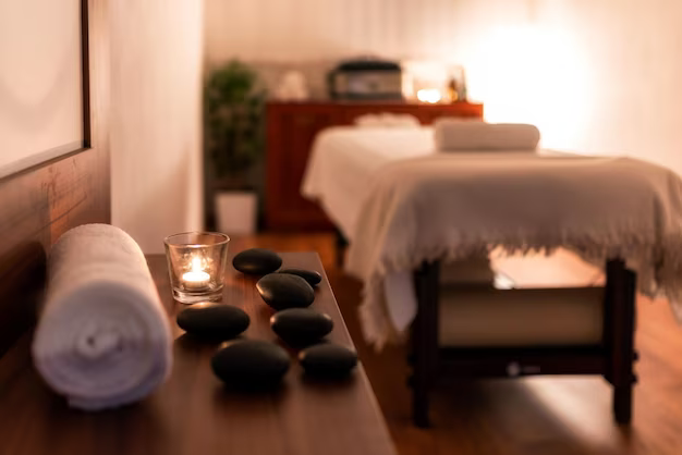Candle, towel and lava stones in spa salon