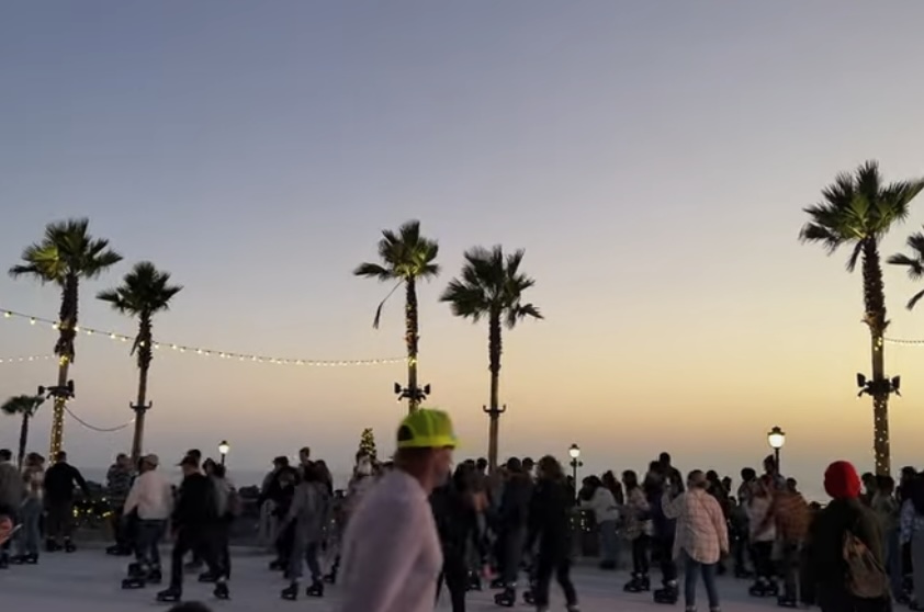 People Skating by the Sea