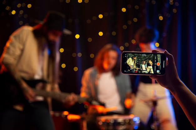 A man films artists singing on his phone