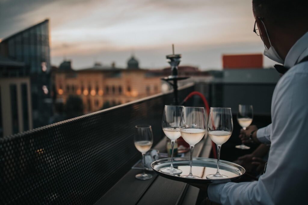 Waiter holding a tray with glasses of white wine