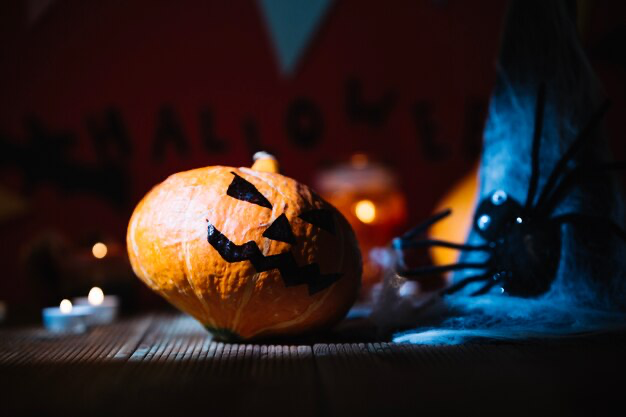 Painted pumpkin in Halloween composition